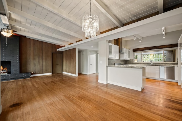 1095 W San Ramon Ave, Fresno, CA 93711 - kitchen with stainless steel dishwasher, white cabinets, open floor plan, light wood finished floors, and a chandelier