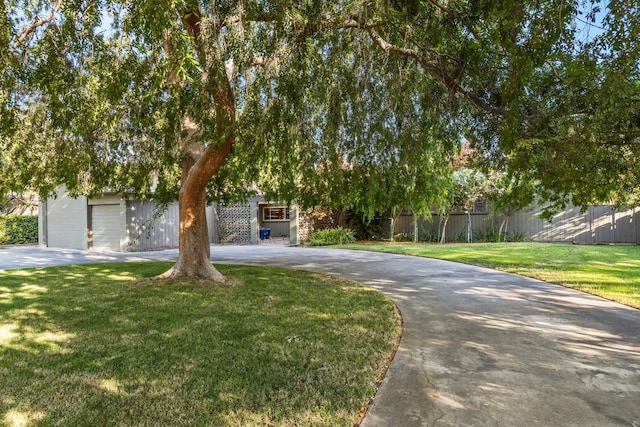 1095 W San Ramon Ave, Fresno, CA 93711 - view of property hidden behind natural elements featuring curved driveway and a garage