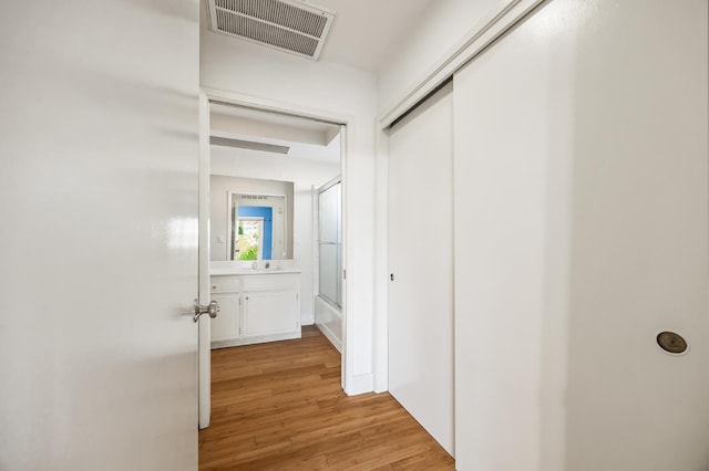 1095 W San Ramon Ave, Fresno, CA 93711 - hall with light wood-style floors and a sink