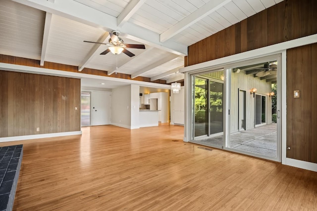 1095 W San Ramon Ave, Fresno, CA 93711 - empty room featuring ceiling fan, light wood finished floors, wood walls, and a chandelier