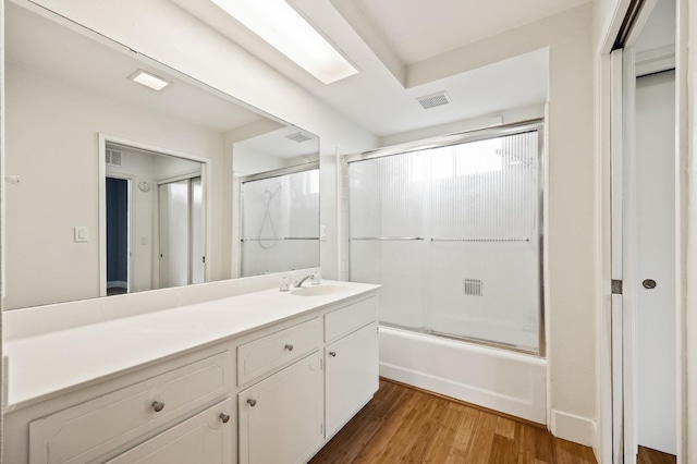 1095 W San Ramon Ave, Fresno, CA 93711 - bathroom featuring vanity, bath / shower combo with glass door, and wood finished floors