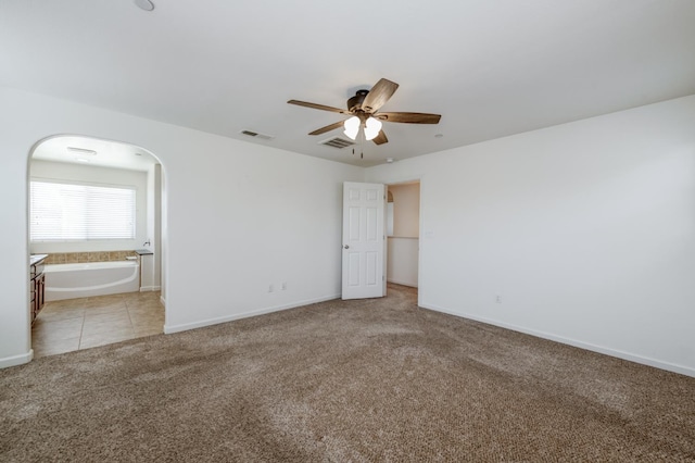 3563 Magnificent Way, Clovis, CA 93619 - unfurnished bedroom with light colored carpet, ensuite bathroom, arched walkways, and ceiling fan