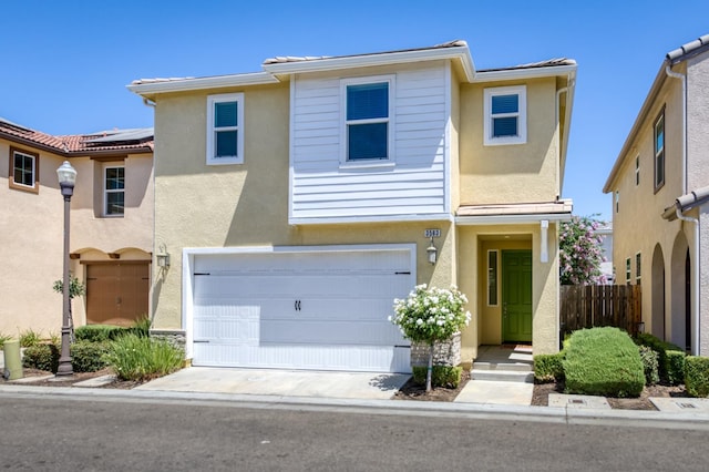 3563 Magnificent Way, Clovis, CA 93619 - townhome / multi-family property with stucco siding, roof mounted solar panels, a garage, and driveway