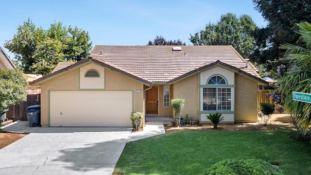 5137 W Stuart Ave, Fresno, CA 93722 - single story home featuring driveway, a garage, a tiled roof, and stucco siding