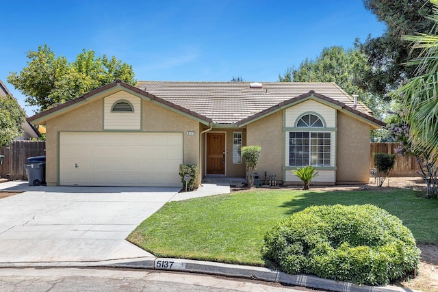 5137 W Stuart Ave, Fresno, CA 93722 - ranch-style house featuring a tiled roof, a garage, stucco siding, and driveway