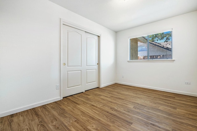 5137 W Stuart Ave, Fresno, CA 93722 - unfurnished bedroom featuring wood finished floors and a closet