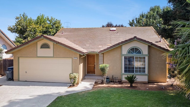 5137 W Stuart Ave, Fresno, CA 93722 - ranch-style home with driveway, an attached garage, stucco siding, and a tile roof