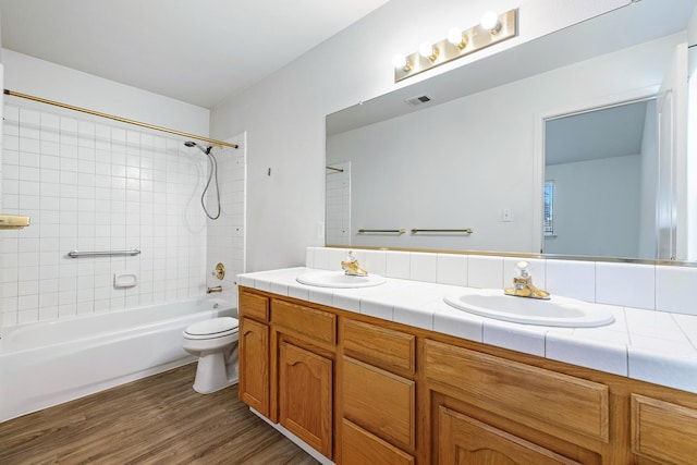 5137 W Stuart Ave, Fresno, CA 93722 - bathroom with double vanity,  shower combination, and wood finished floors