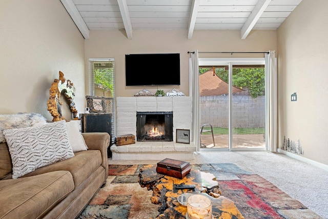 317 W Sierra Ave Unit 107, Fresno, CA 93704 - living area with carpet floors, beamed ceiling, healthy amount of natural light, and a brick fireplace