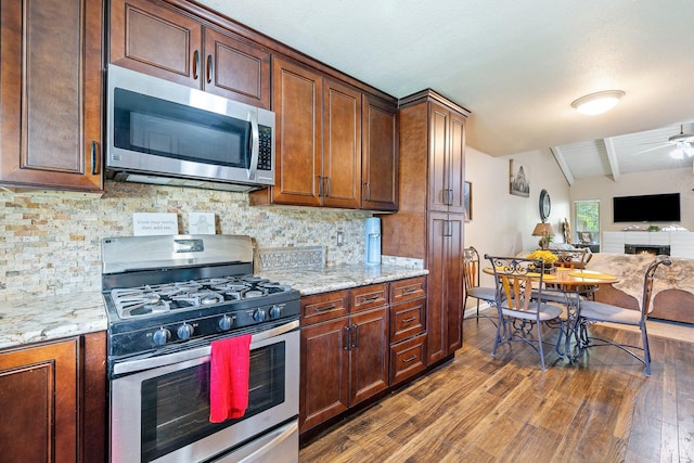 317 W Sierra Ave Unit 107, Fresno, CA 93704 - kitchen featuring stainless steel appliances, dark wood finished floors, tasteful backsplash, and open floor plan