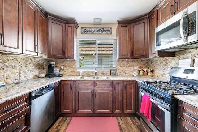317 W Sierra Ave Unit 107, Fresno, CA 93704 - kitchen featuring stainless steel appliances, dark wood finished floors, backsplash, and light stone countertops