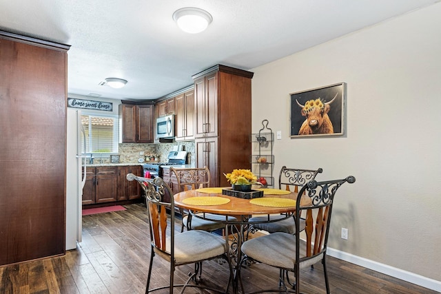 317 W Sierra Ave Unit 107, Fresno, CA 93704 - dining area with dark wood-style flooring and baseboards