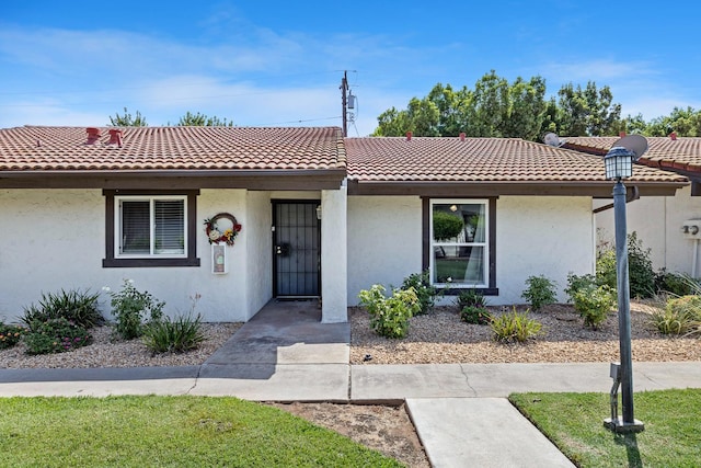 317 W Sierra Ave Unit 107, Fresno, CA 93704 - view of front of home with stucco siding and a tiled roof