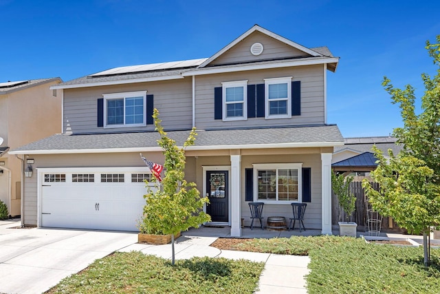 4053 Rialto Ave, Clovis, CA 93619 - view of front of property featuring covered porch, solar panels, concrete driveway, a garage, and a shingled roof