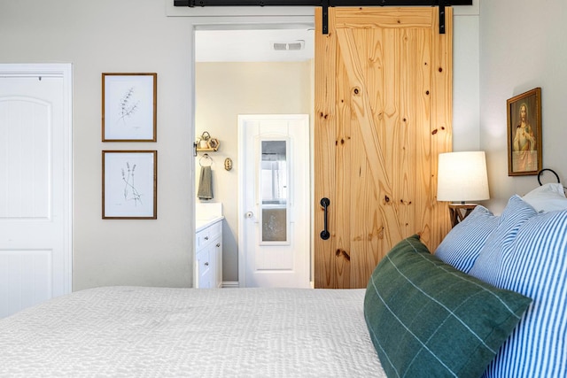 4053 Rialto Ave, Clovis, CA 93619 - bedroom featuring a barn door and ensuite bathroom