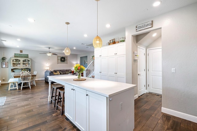 4053 Rialto Ave, Clovis, CA 93619 - kitchen with dark wood-style flooring, a ceiling fan, a kitchen island, open floor plan, and recessed lighting