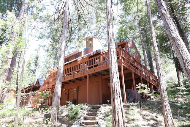 42045 Jeffrey Ln, Shaver Lake, CA 93664 - back of house featuring stairway, a deck, and a chimney