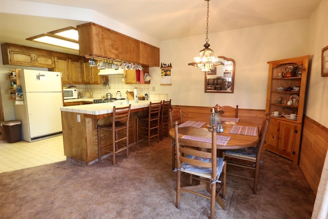 42045 Jeffrey Ln, Shaver Lake, CA 93664 - dining area with a chandelier, dark colored carpet, and wooden walls