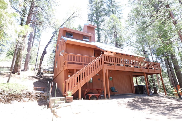 42045 Jeffrey Ln, Shaver Lake, CA 93664 - view of front of house with a wooden deck, a metal roof, and stairway