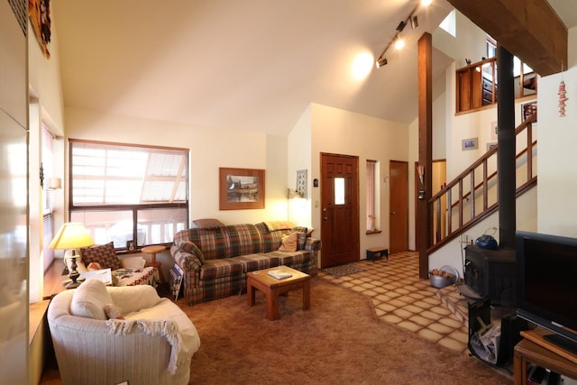 42045 Jeffrey Ln, Shaver Lake, CA 93664 - living room with carpet flooring, high vaulted ceiling, a wood stove, stairway, and rail lighting