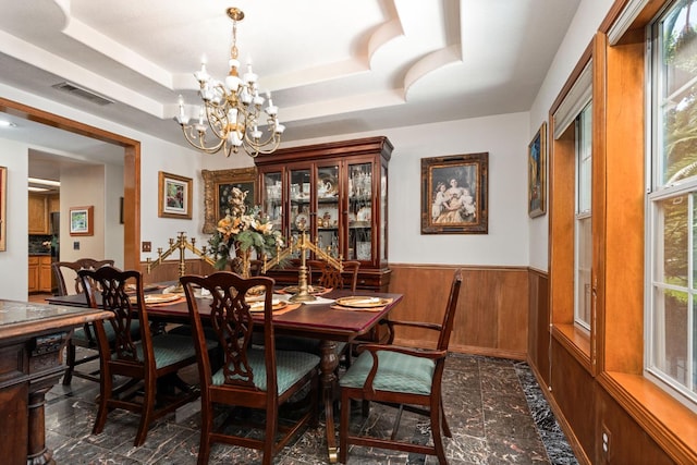 7207 E Bremer Ave, Fresno, CA 93737 - dining room with a wainscoted wall, a chandelier, a tray ceiling, and wooden walls