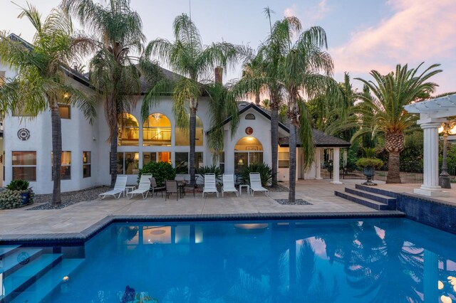 7207 E Bremer Ave, Fresno, CA 93737 - pool at dusk featuring an outdoor pool and a patio area