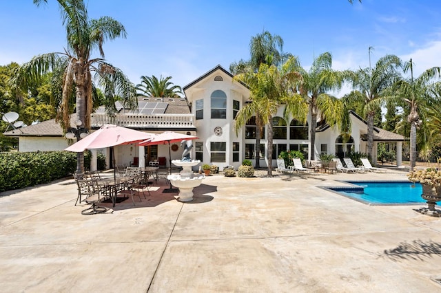 7207 E Bremer Ave, Fresno, CA 93737 - rear view of property featuring a patio, a community pool, and stucco siding