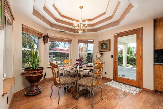 7207 E Bremer Ave, Fresno, CA 93737 - dining room with plenty of natural light, a chandelier, and a tray ceiling