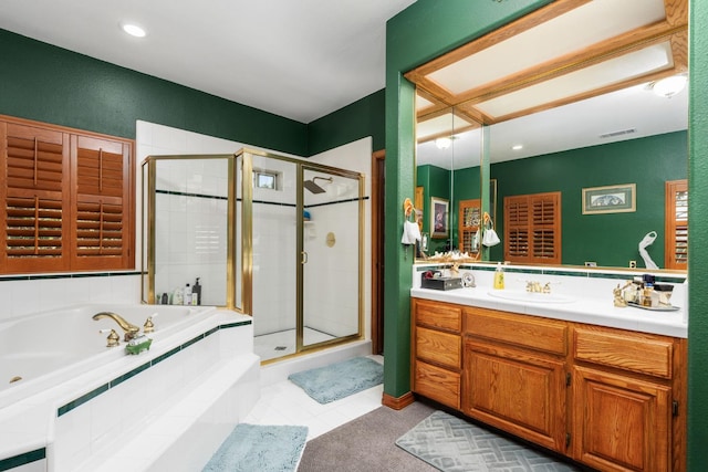 7207 E Bremer Ave, Fresno, CA 93737 - bathroom featuring a stall shower, a jetted tub, vanity, tile patterned flooring, and recessed lighting