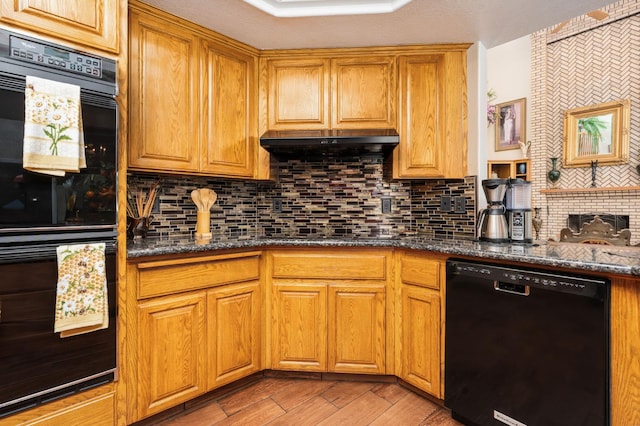 7207 E Bremer Ave, Fresno, CA 93737 - kitchen featuring black appliances, decorative backsplash, dark stone countertops, under cabinet range hood, and brown cabinets