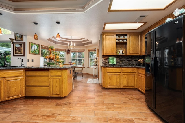 7207 E Bremer Ave, Fresno, CA 93737 - kitchen featuring black fridge with ice dispenser, a tray ceiling, brown cabinetry, and light wood finished floors