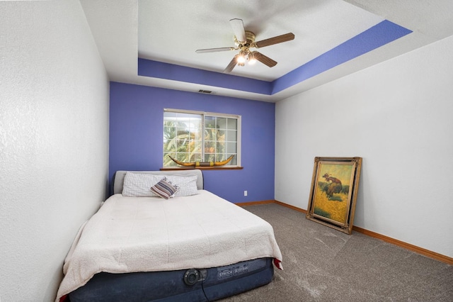 7207 E Bremer Ave, Fresno, CA 93737 - bedroom with carpet flooring, a tray ceiling, and a ceiling fan