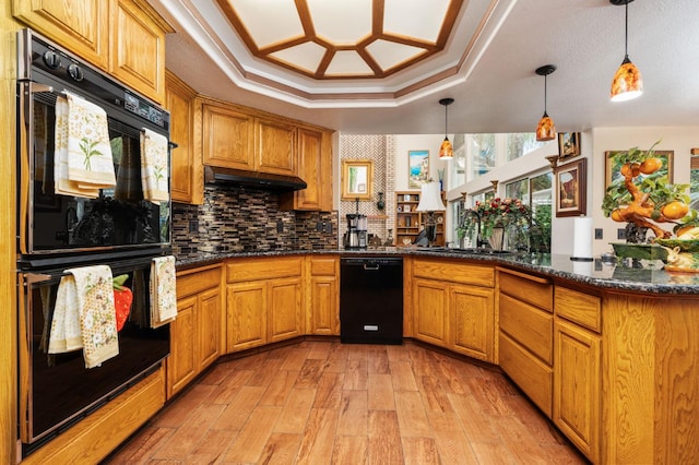 7207 E Bremer Ave, Fresno, CA 93737 - kitchen with black appliances, a peninsula, light wood-style floors, decorative light fixtures, and a tray ceiling
