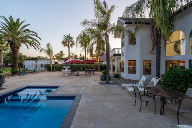 7207 E Bremer Ave, Fresno, CA 93737 - pool at dusk with a patio area