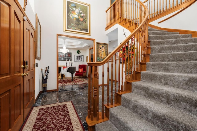 7207 E Bremer Ave, Fresno, CA 93737 - foyer with a towering ceiling, stairs, and dark marble finish floors