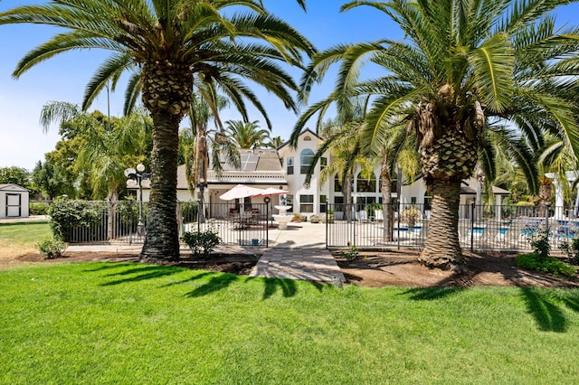 7207 E Bremer Ave, Fresno, CA 93737 - view of yard with a storage unit and a community pool