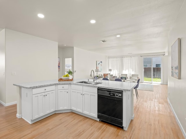 2303 S Bush Ave, Fresno, CA 93727 - kitchen with dishwasher, open floor plan, light wood-style flooring, white cabinetry, and recessed lighting