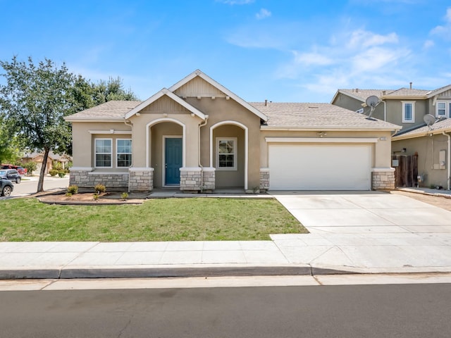 2303 S Bush Ave, Fresno, CA 93727 - view of front of property with stone siding, stucco siding, a garage, driveway, and a front yard