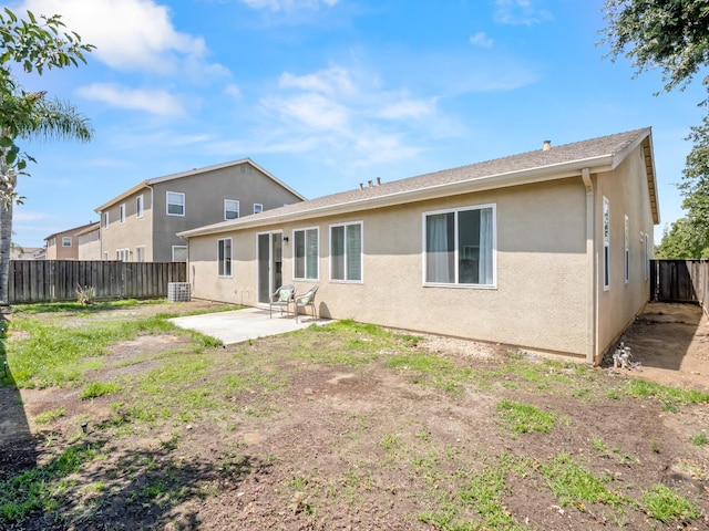 2303 S Bush Ave, Fresno, CA 93727 - back of property with a patio, a fenced backyard, and stucco siding