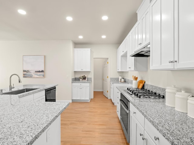 2303 S Bush Ave, Fresno, CA 93727 - kitchen with stainless steel appliances, under cabinet range hood, recessed lighting, white cabinets, and light wood-style flooring