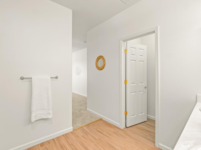 2303 S Bush Ave, Fresno, CA 93727 - corridor with light wood-style flooring and baseboards