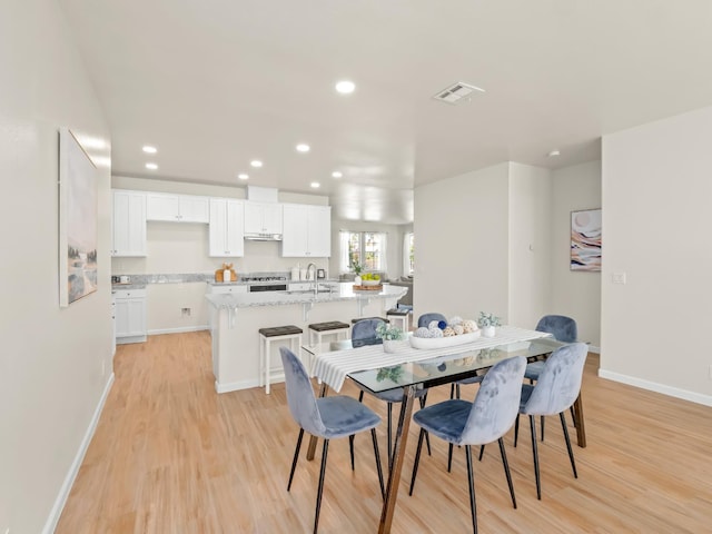 2303 S Bush Ave, Fresno, CA 93727 - dining area with light wood-style flooring and recessed lighting