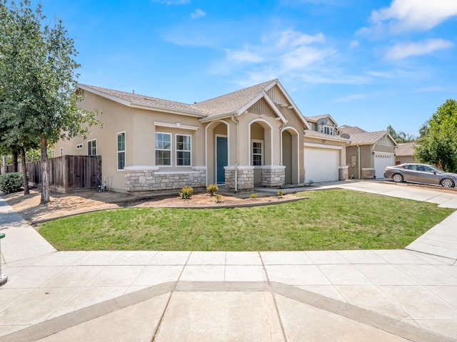 2303 S Bush Ave, Fresno, CA 93727 - view of front of home featuring concrete driveway, stucco siding, stone siding, and a garage