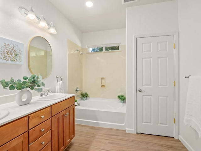 2303 S Bush Ave, Fresno, CA 93727 - full bath with double vanity, wood finished floors, and tub / shower combination