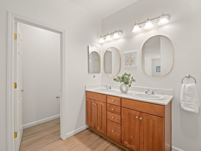 2303 S Bush Ave, Fresno, CA 93727 - bathroom featuring wood finished floors and double vanity
