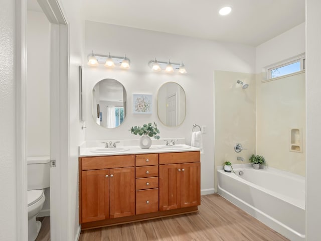 2303 S Bush Ave, Fresno, CA 93727 - bathroom with wood finished floors, double vanity, and bathing tub / shower combination