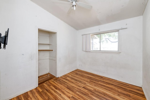 22 Beverly Dr, Clovis, CA 93612 - unfurnished bedroom featuring wood finished floors, vaulted ceiling, a closet, and a ceiling fan