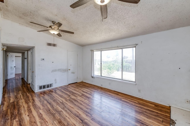 22 Beverly Dr, Clovis, CA 93612 - unfurnished room featuring a ceiling fan, lofted ceiling, a textured ceiling, and wood finished floors