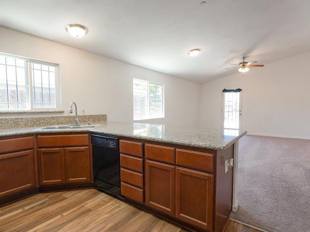 435 E San Pedro St, Merced, CA 95341 - kitchen featuring black dishwasher, a peninsula, brown cabinetry, ceiling fan, and lofted ceiling