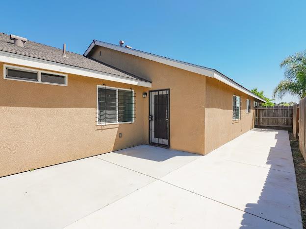 435 E San Pedro St, Merced, CA 95341 - rear view of property with stucco siding and a patio